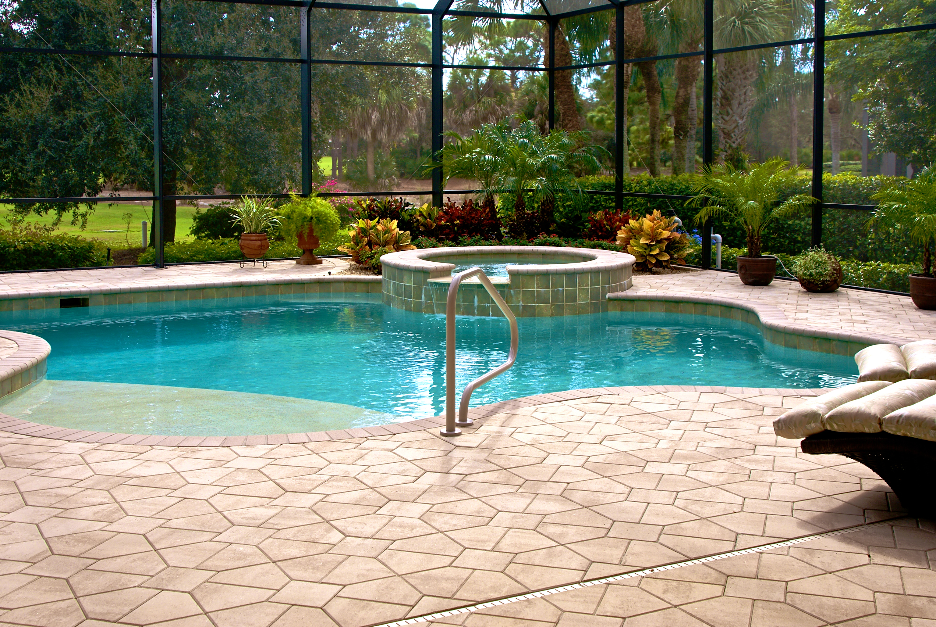 https://www.paversblocks.com/wp-content/uploads/2015/06/Brick-pool-coping-swimming-pool-with-plants-and-hardscape-design-oval-pool-and-hot-tub-pool-2.jpg